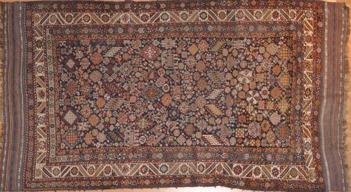 GASHGAI antique.Black background geometrically patterned with stylized plants and animals, white edging with trailing flowers, signs of wear, 160x274 cm.