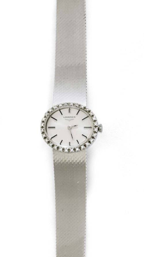 DIAMOND LADY'S WRISTWATCH, LONGINES, ca. 1970. White gold 750, 47g. Oval case in white gold, case No. 33708 with diamond lunette weighing ca. 0.50 ct. Silver-coloured dial with applied indices with black lines and the hands painted black. Hand winder, movement No. 51789374, Cal. 460. Satin-finished Milanaise gold band, not original, L ca. 17 cm. D 22 x 25 mm.