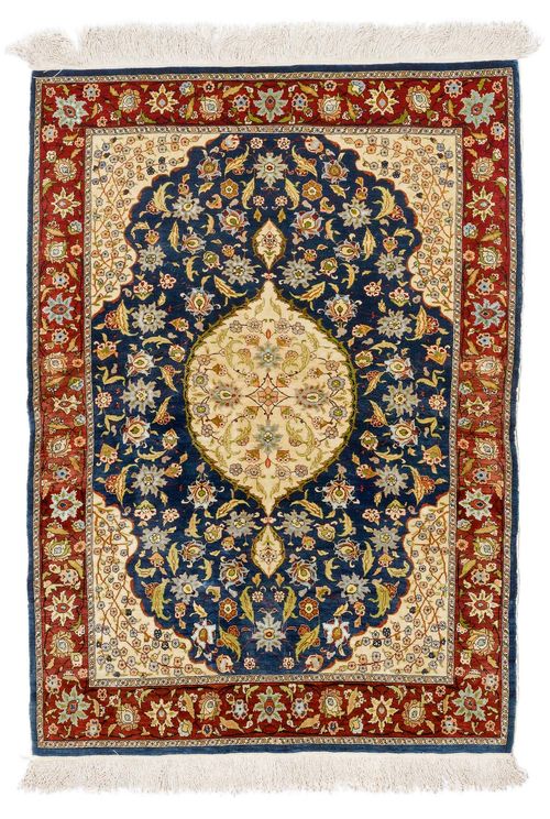 HEREKE SILK old.Blue central field with a beige central medallion and corner motifs, patterned with trailing flowers and palmettes, red edging, 85x117 cm.
