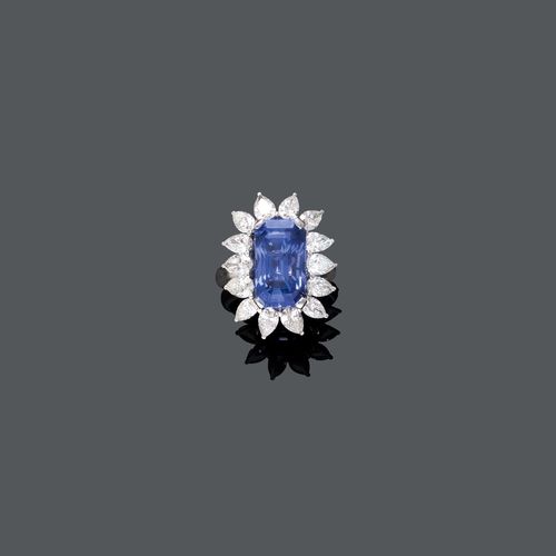 SAPPHIRE AND DIAMOND RING, ca. 1960. White gold 750. Classic-elegant ring, the top set with 1 step-cut Ceylon sapphire weighing ca. 12.67 ct, unheated, within a border of 14 drop-cut diamonds weighing  ca. 3.50 ct. Size ca. 58. With GII Report No. ORG-1201762-001, September 2012.