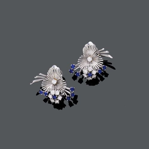 SAPPHIRE AND DIAMOND EAR CLIPS, ca. 1960. White gold 750. Decorative ear clips designed as stylized blossoms, each blossom set with 1 sapphire and 6 brilliant-cut diamonds, each bud set with 5 sapphires, and each leaf set with 1 brilliant-cut diamond. Total weight of the sapphires ca. 0.50 ct and total weight of the diamonds ca. 0.70 ct. Engraved Van Cleef & Arpels model, 1958. With original case.