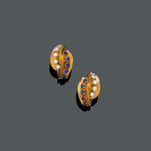 SAPPHIRE, DIAMOND AND GOLD EAR CLIPS, VAN CLEEF & ARPELS, ca. 1950. Yellow gold 750, 14g. Decorative, finely engraved ear clips, each designed as 2 stylized leaf motifs  set with 5 brilliant-cut diamonds, total weight of the diamonds ca. 0.60 ct, and 5 sapphires, total weight of the sapphires ca. 0.50 ct. Signed VCA, No. 81214.
