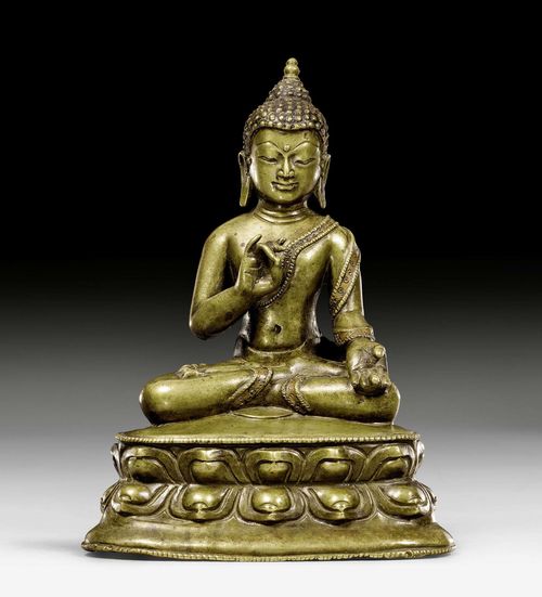 AN EARLY BRONZE FIGURE OF A PREACHING BUDDHA. Tibet, 14th/15th c. Height 16.5 cm. Seams inlaid with copper.