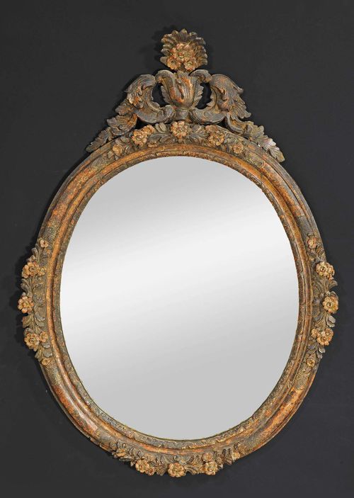OVAL MIRROR, Louis XV, northern Italy circa 1750. Pierced and richly carved wood with remains of old paint. H 113 cm, W 80 cm.