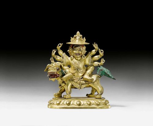 A GILT BRONZE FIGURE OF PEHAR SEATED ON A LION. Tibeto-chinese, 19th c. Height 15.5 cm.