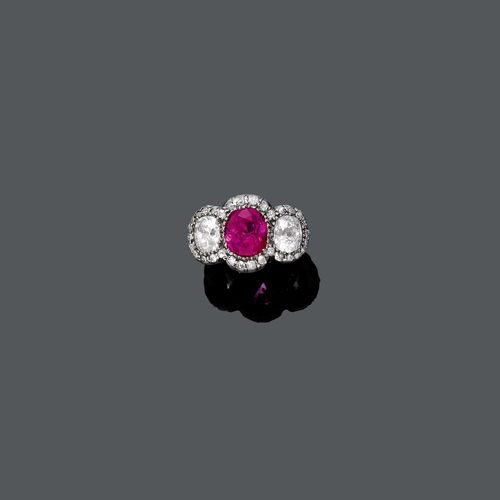 BURMA RUBY AND DIAMOND RING, ca. 1900. Silver over yellow gold. Fancy ring, the top set with 1 fine, oval Burma ruby weighing 3.41 ct, flanked by 2 oval, old European cut diamonds weighing ca. 1.60 ct, the frame additionally decorated with 30 old European cut diamonds and single-cut diamonds weighing ca. 0.40 ct in total. The ruby needs resetting. Size ca. 57. With GPL Report No. 08100, July 2013.