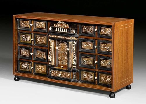SMALL CABINET,Baroque, Vizagapatam circa 1700. Amaranth, rosewood and ebony, partly ebonized and inlaid with fine ivory fillets and decorative frieze. The front with central drawer between 2 drawers, flanked on each side by 1 pull-out column with secret compartment and 3 drawers. Ivory knobs. 79x25x45 cm.