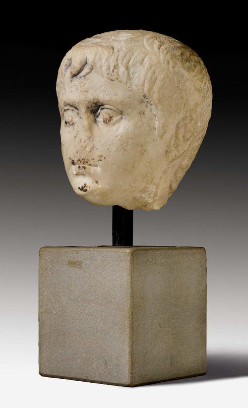 MARBLE HEAD OF AN IMPERATOR,Roman, probably 1st century A.D. White marble. Mounted on a gray granite plinth. Remnants of later painting. Some chips. H head 24 cm, with plinth 46 cm.