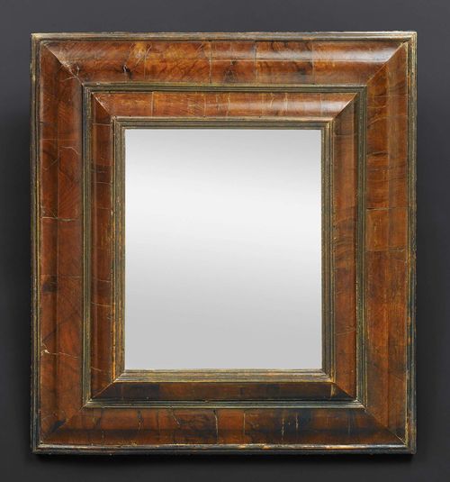 MIRROR,Baroque, German circa 1680. Shaped walnut and burlwood in veneer. Beveled mirror plate. H 61 cm, 53 cm.