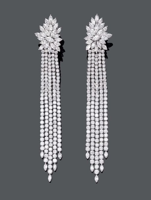 DIAMOND EAR PENDANTS. White gold 750, 58g. Very fancy, decorative ear clips with studs, each of 1 stylised blossom with 23 navette-cut diamonds. Suspended therefrom: 5 flexible lines of brilliant-cut diamonds of different lengths, the lower part with 1 navette-cut diamond. Total diamond weight ca. 26.80 ct. L ca. 11.5 cm.