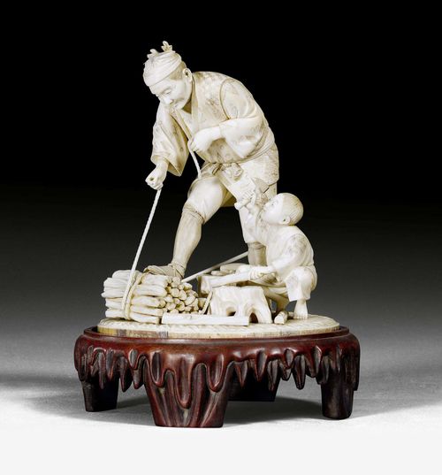AN IVORY OKIMONO OF A WOOD COLLECTOR WITH HIS CHILD. Japan, Meiji period, height 16 cm. Crack at base, minor damage. Wood base.