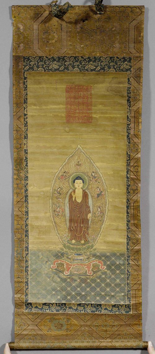 A HANGING SCROLL OF AMIDA NYORAI WITH A LARGE SEAL. Japan, Edo period, 54x23.5 cm. Ink, colours and gold on silk. Stains.