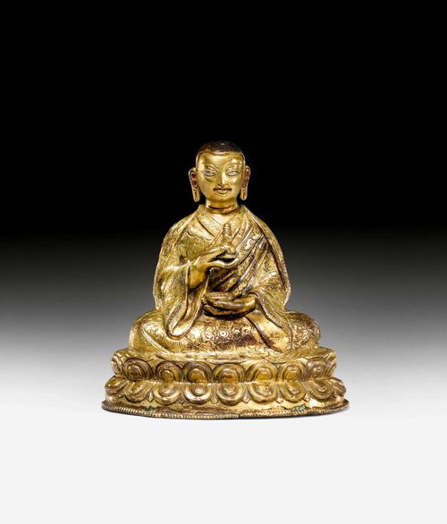 A GILT COPPER FIGURE OF A HIGH RANKING LAMA. Southern Tibet, 14th c. Height 12.5 cm.