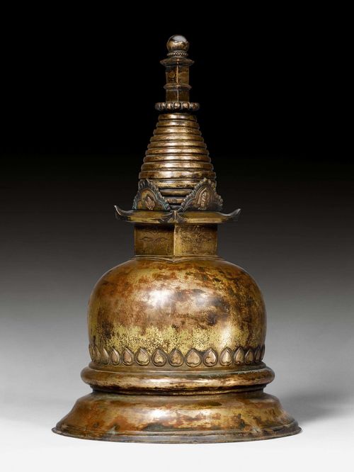 A LARGE GILT COPPER REPOUSSÉ STUPA TOPPED BY A CRYSTAL. Nepal, 17th c. Height 42.5 cm.