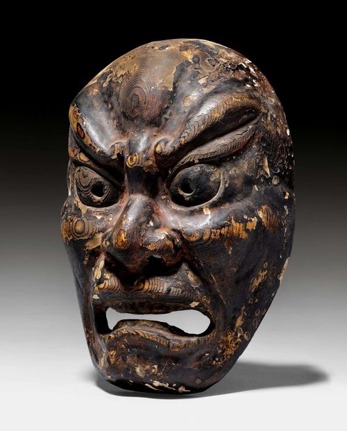 A WOOD BUGAKU AGYÔ-MASK. Japan, Edo-period or earlier, height 27 cm. Remains of paint.