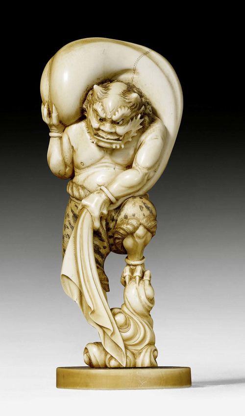 AN IVORY OKIMONO OF FUJIN, THE GOD OF WIND. Japan, around 1920, height 15.5 cm. Signed.