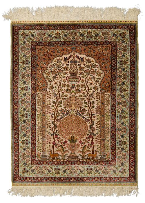 HEREKE SILK, PRAYER.Fineness: 10x10 knots/cm2. Mihrab with beige spandrels and gold brocade, finely patterned with a flower vase and animals in delicate pastel colours, light border with trailing flowers and palmettes, in good condition, 127x159cm.