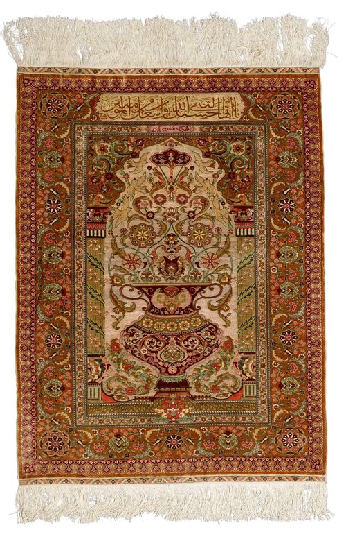 HEREKE SILK, PRAYER.Fineness: 10x10 knots/cm2. Mihrab with brown spandrels and gold brocade, finely decorated with a flower vase and birds, brown border with trailing flowers and palmettes, 102x135cm.