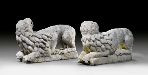 PAIR OF SIMILAR LIONS IN STONE, in the Romanesque style, Italy. Grey stone. Reclining lion, head turned upwards, on a rectangular base. Strong signs of weathering, losses. L ca. 84 cm. H ca. 54 cm. Provenance: - Koller Auction, Zurich, 20 June 2011, Lot No. 5324. - from the collection of the Marquise de Amodio y Moya.
