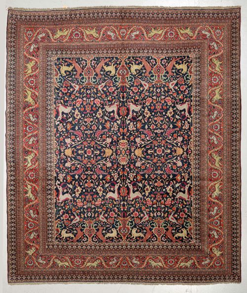 DOROSH antique.Dark blue central field, opulently patterned with plants and animals in bright colours, dusky pink border with tendrils and animals, in good condition, 290x333 cm.