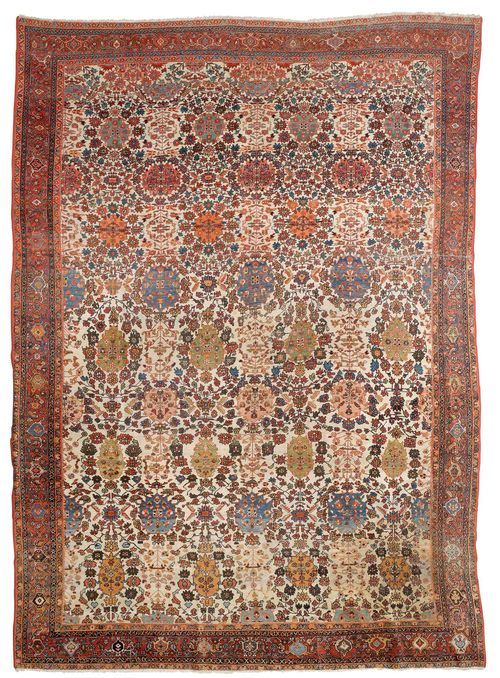 FERAGHAN antique.White ground, patterned throughout with floral medallions in delicate pastel colours, rust-coloured edging with stylised tendrils, signs of wear and restored in some areas, 265x370 cm.