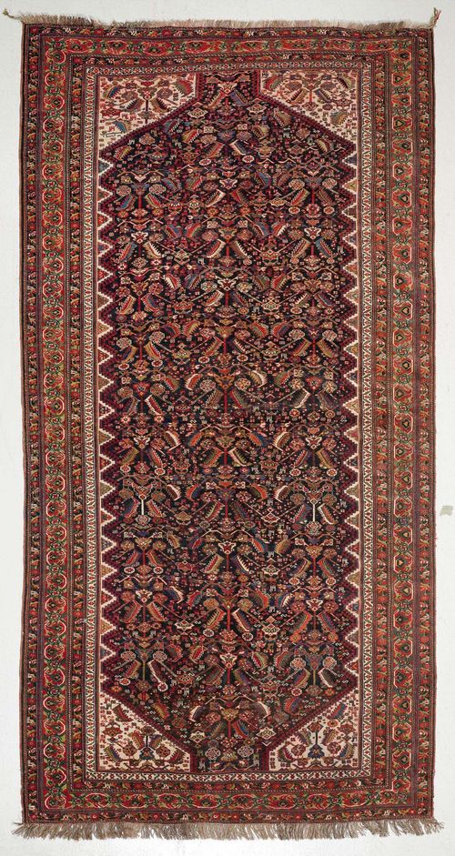 GASHGAI old.Dark central field, patterned with stylised plants and animals, stepped border in red and white with stylised tendrils, in good condition, 174x327 cm.