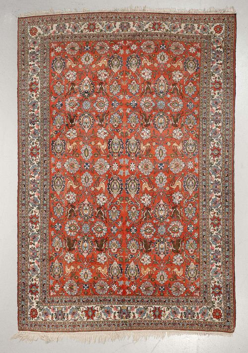 GHOM old.Red ground, patterned throughout with trailing flowers, palmettes and animals, slight wear, 218x336 cm.