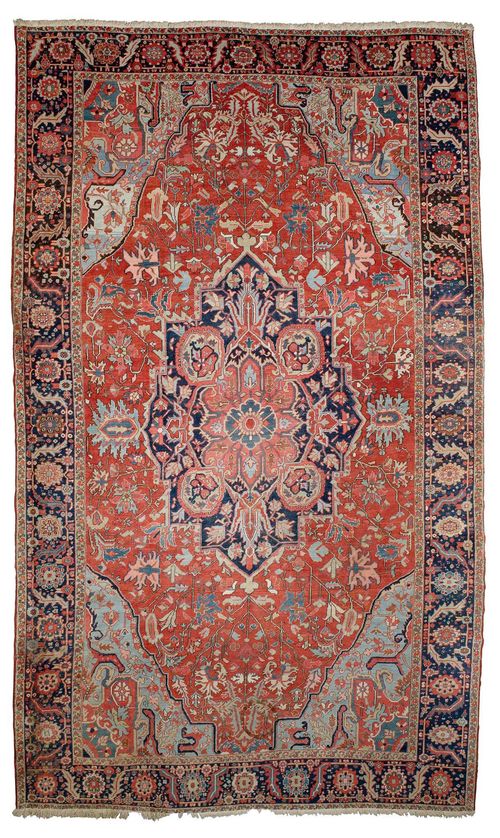 HERIZ antique.Red ground with a bulky central medallion and light blue corner motifs, typically patterned with stylised plant motifs, black edging with trailing flowers, slight wear, 350x560 cm.