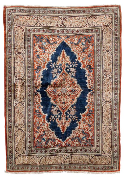 HERIZ SILK antique.Floral central medallion on a blue and rust-coloured ground, finely patterned with trailing flowers in harmonious colours, beige border with inscription cartouches, slightly stained, otherwise in good condition, 140x192 cm.