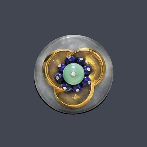 LAPIS LAZULI, JADEITE, DIAMOND AND ROCK CRYSTAL BROOCH, CARTIER, London, ca. 1970. Yellow gold 750. Decorative, round brooch of rock crystal, the centre set with 1 jadeite bead of ca. 13 mm Ø with 1 small old European-cut diamond set in platinum, within a border of 8 lapis lazuli beads of ca. 6.5 mm Ø with a diamond and 3 half-spherical, convex gold elements. Signed Cartier London, maker's mark JC No. 2426. D ca. 4.9 cm. Matches the following lot.