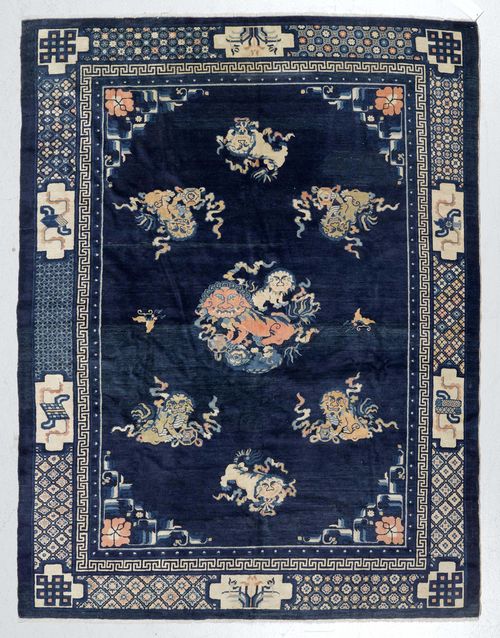 CHINA antique.Dark blue central field patterned with medallions in the shape of dragons, blue border with stylised floral motifs, slight wear, 180x230cm.