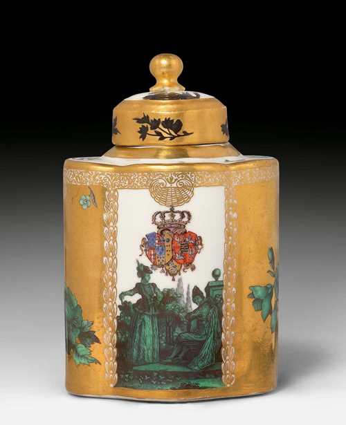IMPORTANT MEISSEN ARMORIAL TEA CADDY FROM THE TOILETRY SERVICE FOR QUEEN MARIA AMALIA OF NAPLES AND SICILY, PRINCESS OF SAXONY, Meissen, ca. 1745-46. Decorated by Gottlob Siegmund Birckner, 'glazed' with copper-green Watteau scenes. Scenes from an Italian comedy. The front with the coat-of-arms of Naples-Sicily and Saxony-Poland. H 13.5 cm. Small hairline crack in the cover, retouched. Signs of a blue sword mark. Provenance: - from the toiletry service for Maria Amalia, Queen of Naples and the Two Sicilies, a present from her mother, Maria Josepha, Electress of Saxony (1699-1757). - from a Zurich private collection.