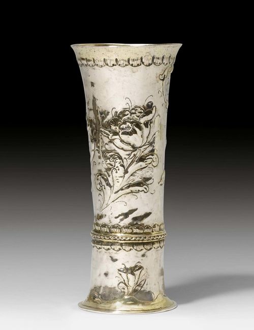BEAKER,probably Hermannstadt, 2nd half of the 17th century, maker's mark Georgius Schnell. Parcel-gilt. Narrow beaker on a cylindrical foot. The walls with chased floral decoration. Cartouche with inscription. H 15.5 cm, 90 g.