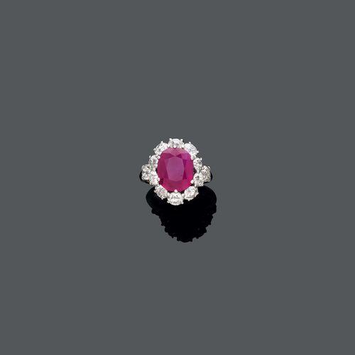 BURMA RUBY DIAMOND RING, ca. 1950. Platinum 950. Set with an oval Burma ruby of ca. 6.50 ct, not heated, and circular-cut diamonds, totalling ca. 3.60 ct. Size ca. 55.