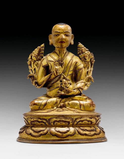 A GILT COPPER ALLOY FIGURE OF A MONK. Tibet, 16th/17th c. Height 14 cm.