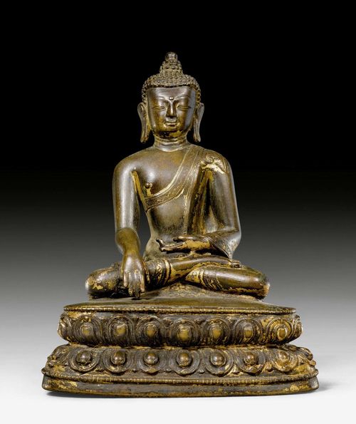 A BRONZE FIGURE OF BUDDHA SHAKYAMUNI WITH TRACES OF GILDING. Tibet, 16th/17th c. Height 14.5 cm.