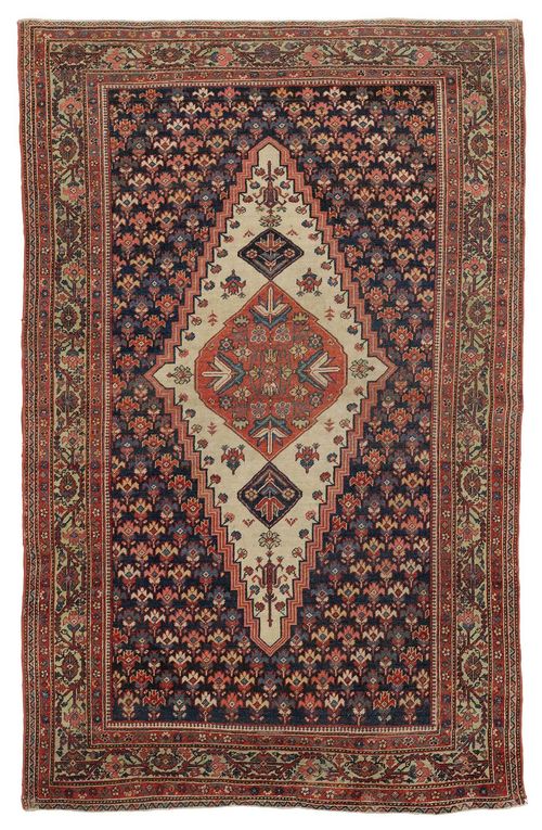 FERAGHAN antique. Dark central field with a dark blue central medallion, patterned with stylised plants, light green border with trailing flowers, signs of wear, 124x196 cm.