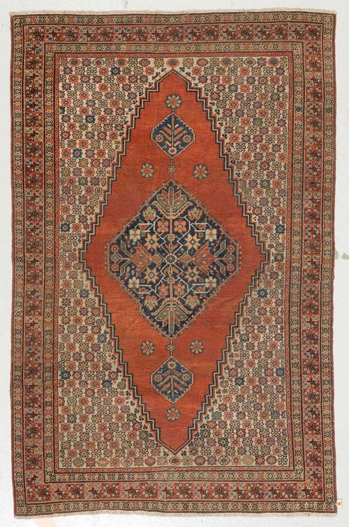 FERAGHAN antique. Black central medallion on a red and white ground, patterned with small floral motifs in delicate pastel colours, rust-coloured border, 123x190 cm.
