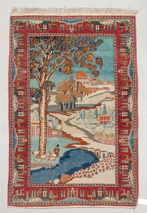 GHOM PICTORIAL CARPET old. City view with landscape, a shepherd with his herd, red border with animals and architectural depictions, slight wear, 134x200 cm.