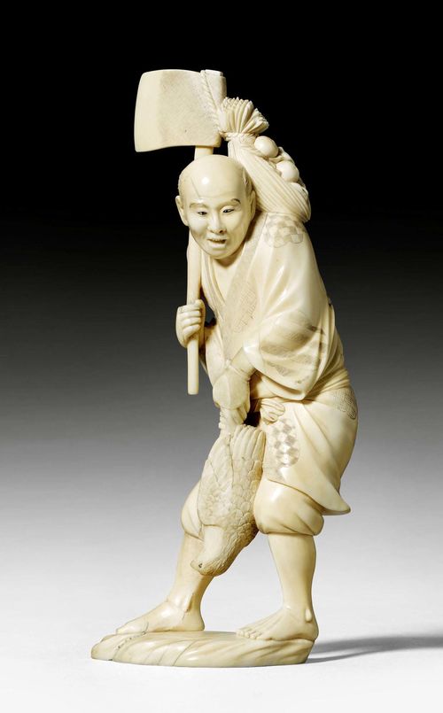 AN IVORY OKIMONO OF A STANDING PAESANT WITH BIRD AND AXE. Japan, Meiji period, height 21.5 cm. Minor cracks.