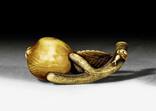 A IVORY NETSUKE OF A CHERRY. Japan, Meiji period, lenght 5 cm. Signed.