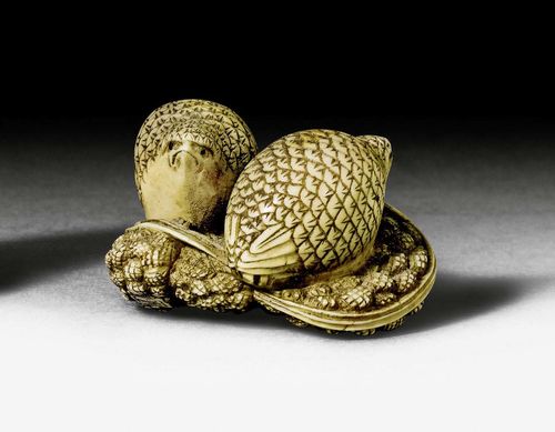 A NETSUKE OF TWO QUAILS IN THEIR NEST. Japan, Meiji period, lenght 2.8 cm. Signed.