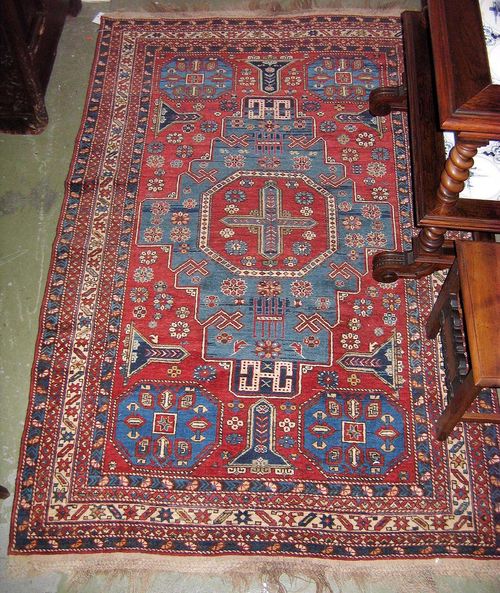 CAUCASIAN old.Red central field with a blue central medallion, the entire carpet is geometrically patterned, wide border, good condition, 190x125 cm.