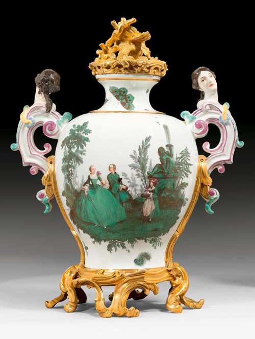 IMPORTANT AND RARE VASE WITH GREEN WATTEAU PAINTING, Meissen, circa 1747. The gilt bronzes, Paris, Louis XV, circa 1750-55. The model by Johann Joachim Kaendler. Painted on both sides in 'camaieu vert' with Watteau-style 'fetes galantes' in copper green, corresponding with the 'Green Watteau Service'. Gilt bronze rocaille base and handles. Crowned by a cast and pierced gilt bronze lid with coral decoration. Underglaze blue sword mark. H 42cm. Provenance: most probably part of a vase set which was given by August III, elector of Saxony, as a gift to the Dauphin and the Dauphine of France in 1747 and displayed in their private chambers in the Palace of Versailles. Illustration: Pierre Kjellberg, Objets Montes du Moyen Age a nos Jours. 2000, p. 79, p. 78; Maureen Cassidy-Geiger, Fragile Diplomacy, Meissen Porcelain for European Courts ca. 1710-1763', 2007, p. 161-162 and p. 162, table 7-28, with detailed discussion and illustration of this vase.