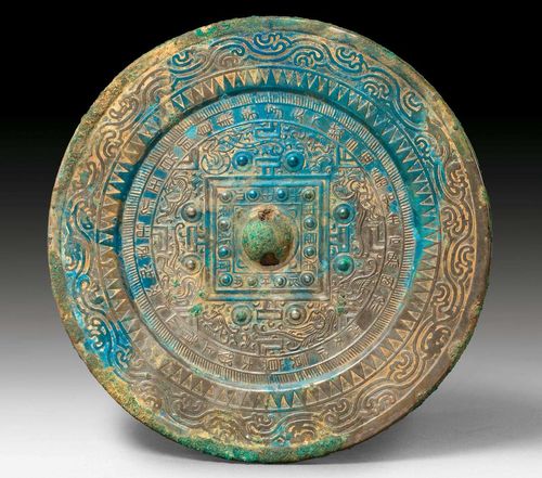 A BRONZE MIRROR WITH TLV DESIGN AND CHINESE CHARACTERS. China, Eastern Han dynasty, diameter 16.5 cm.