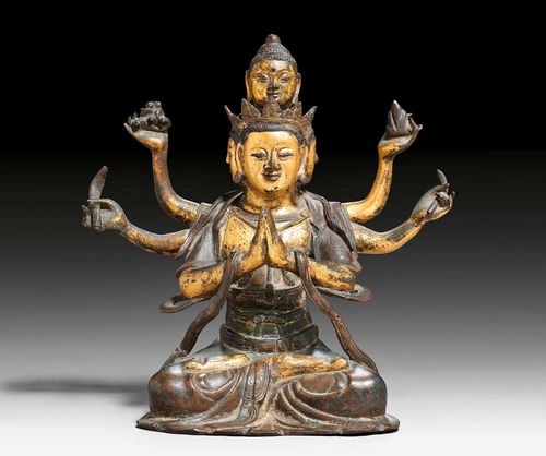 A RARE PARTLY GILT BRONZE FIGURE OF THE SIX ARMED AND FOUR HEADED AVALOKITESHVARA. China, Ming dynasty, height 20.5 cm.