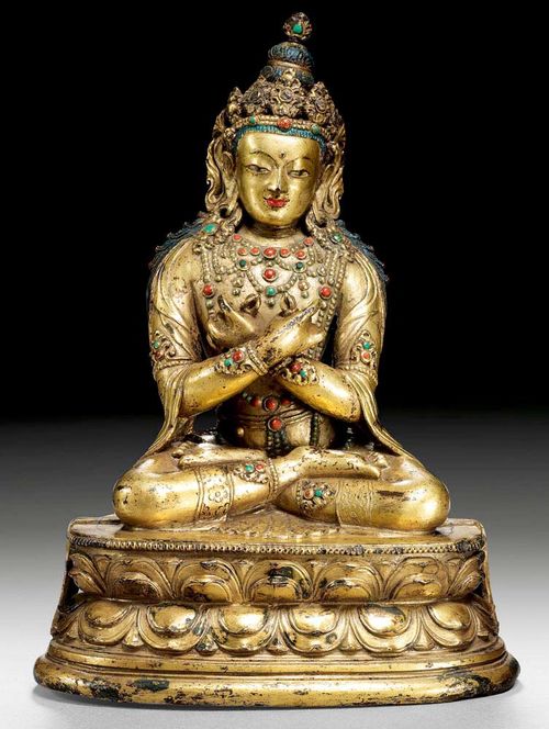 VAJRADHARA.Mongolia, ca. 18th century  H 19.5 cm. Gilt copper alloy. The coloured stones are painted. Plinth missing. The throne slightly indented verso.