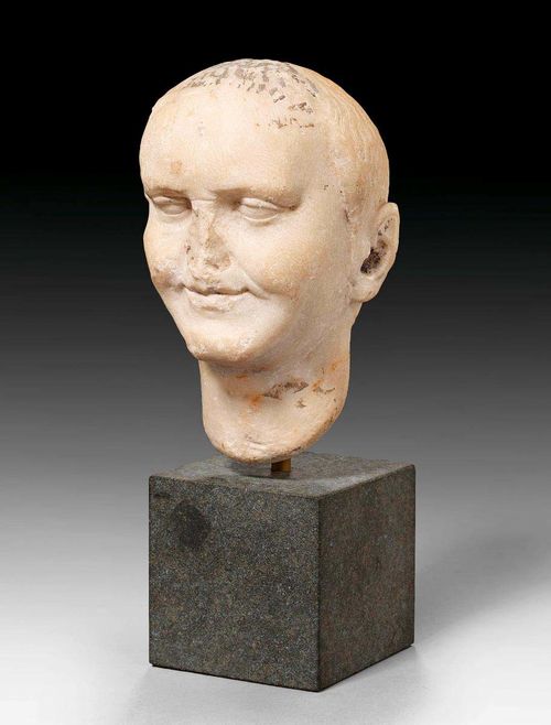 SMALL MARBLE HEAD OF VESPASIAN,Roman, 1st century A.D. Mounted on dark grey stone base. H 16 cm. Provenance: - Koller Auction Zurich on 8.12.2005 (Lot No. 1001). - Private collection, Ascona.