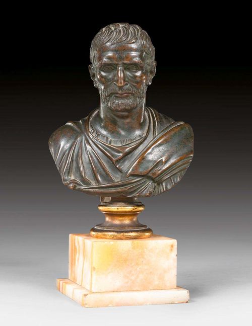 SMALL BRONZE BUST,according to ancient designs, probably Rome, 18th/19th century. Burnished bronze. On later onyx pedestal. H 29 cm.