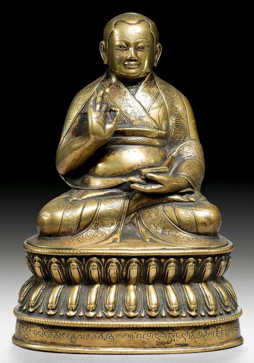 LAMA OF THE SAKYA SCHOOL.Tibet, 16th century  H 14 cm. Ungilded bronze, the eyes inlaid with silver. Inscription on the plinth. Small dent verso. Acquired Nov 1989 at Galerie Koller